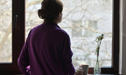 A Self isolate Woman or Quarantine Looking Out