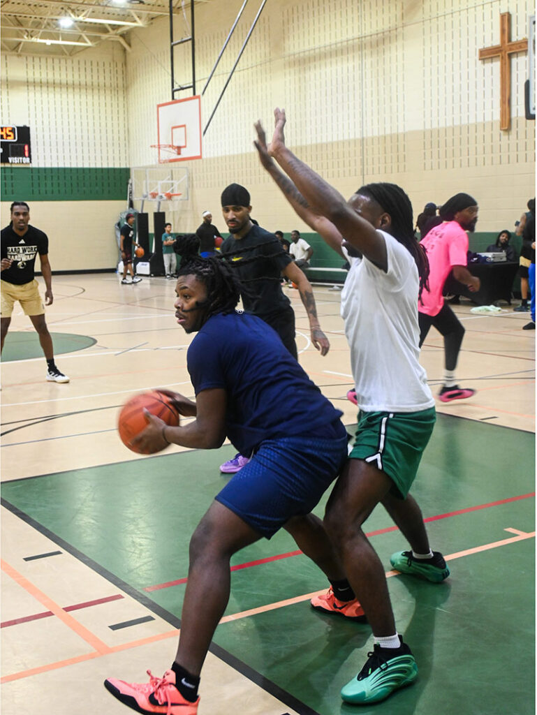 Basketball players shoot hoops in the Cary First gym after hearing the gospel before tipoff.
