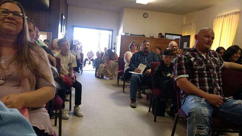 Congregants of First Baptist Church, Duchesne, Utah, spill outside onto the sidewalk as the worship service is filled to capacity.