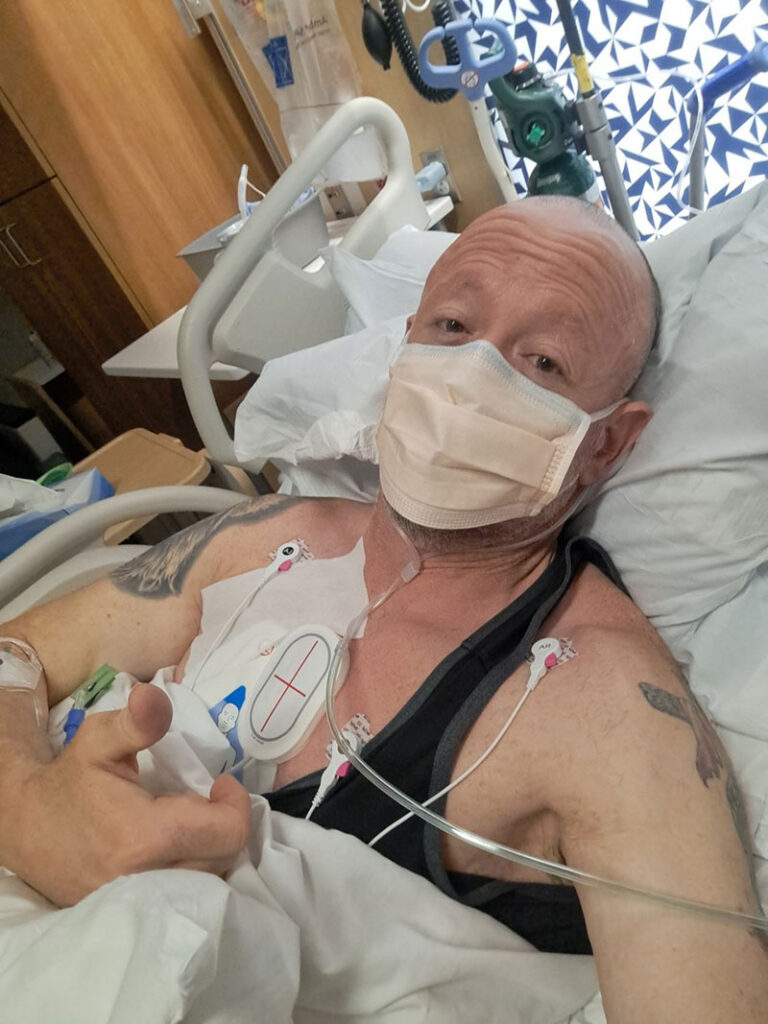 Carl Wimmer gives a thumbs-up after being resuscitated from his cardiac emergency in the hospital.