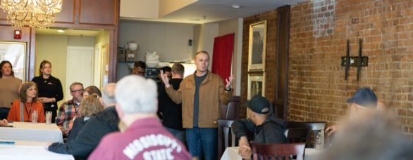 Church planter Jacob Giles speaks to NAMB trustees inside a South Boston restaurant