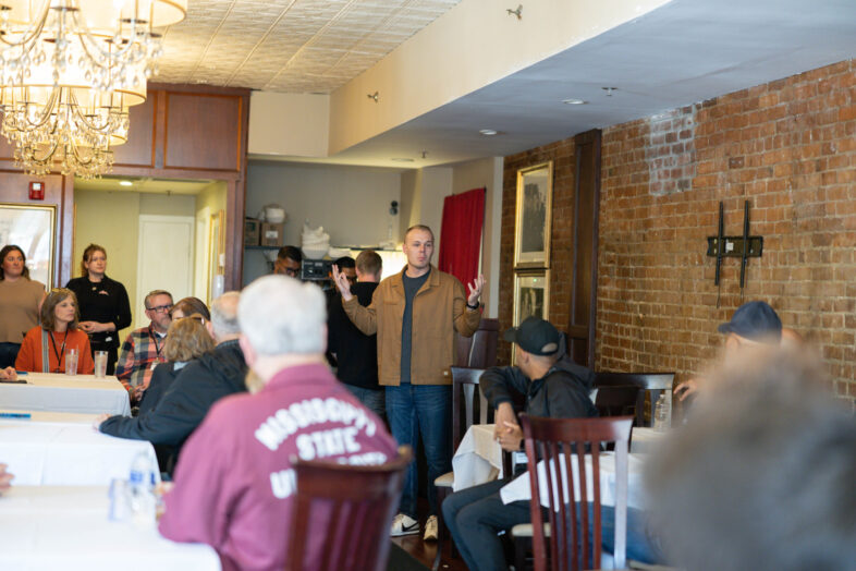 Church planter Jacob Giles speaks to NAMB trustees inside a South Boston restaurant